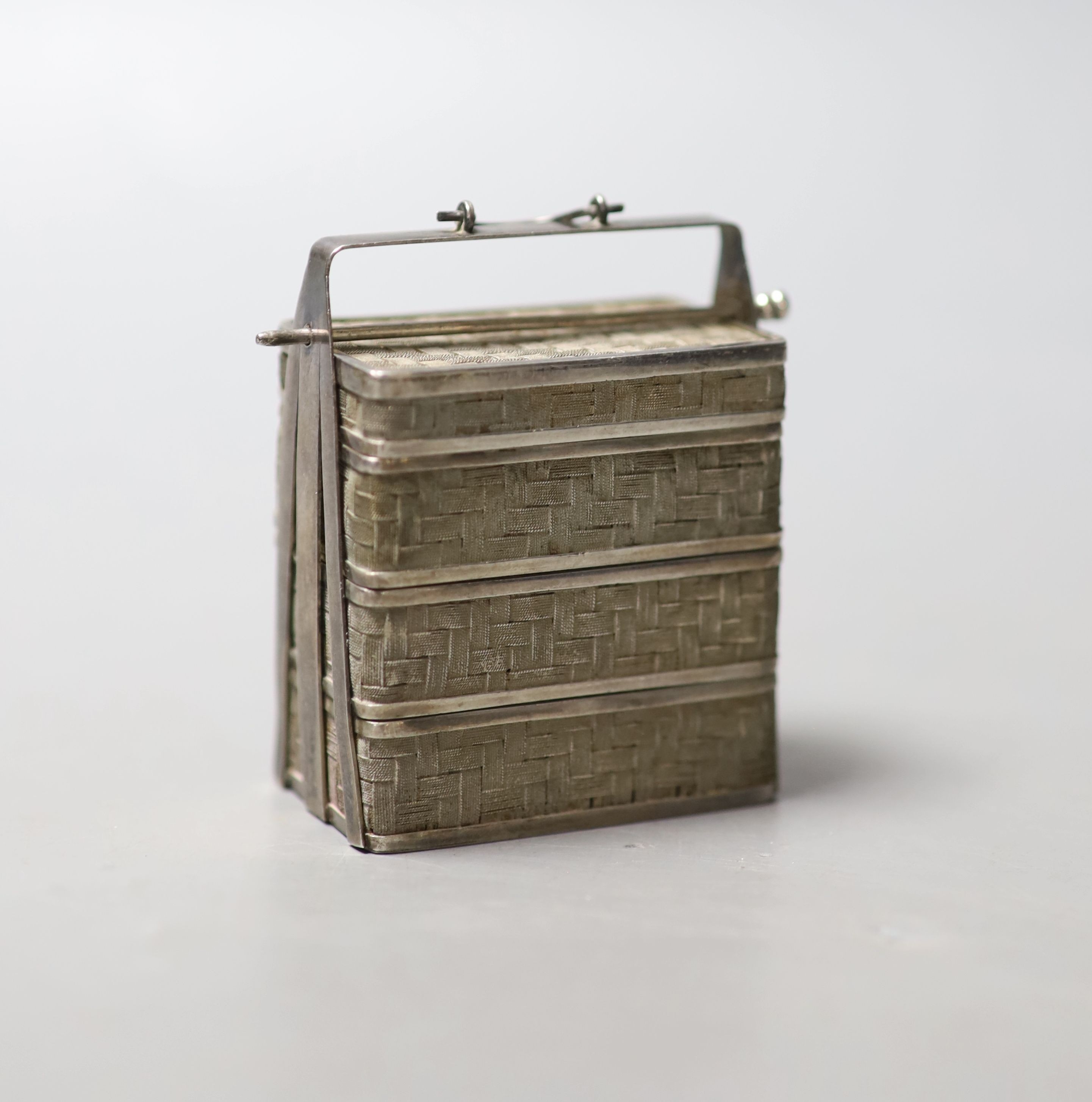 A Japanes white metal miniature model of a three tier picnic basket, height 58mm.